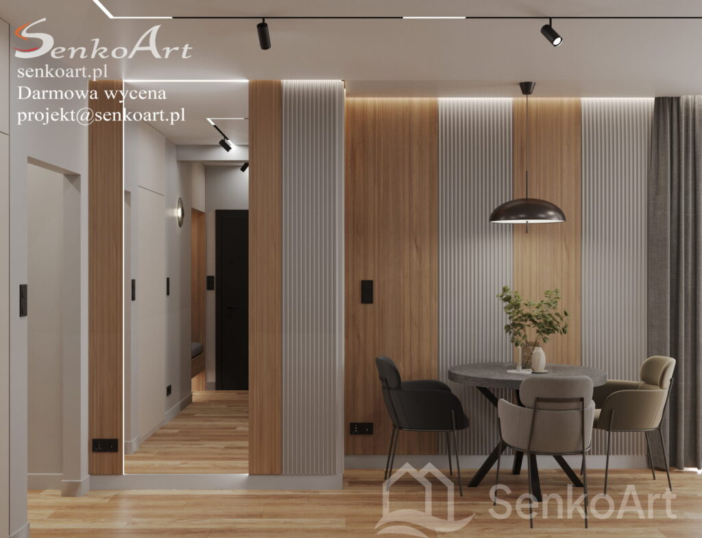 Elegancka, nowoczesna kuchnia z jasnymi szafkami, kamiennym blatem i stylowym oświetleniem, tworząca uporządkowaną przestrzeń.